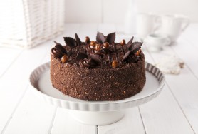 Hazelnut meringue cake with cocoa cream and chocolate